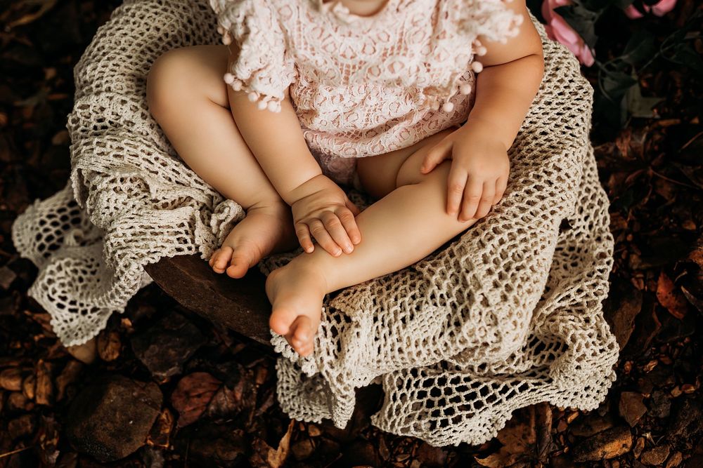 Delicate lace dress details and hands shown in a series of close-up artistic photographs.