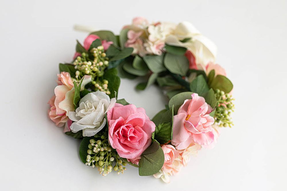 Pink and white floral wreath hair crown with roses and green leaves.