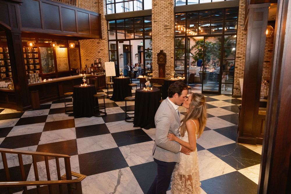 Bride and groom celebrating rehearsal dinner at Oxford Exchange wedding venue in Tampa FL
