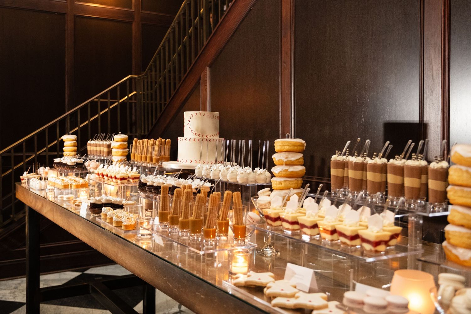 Dessert table at Oxford Exchange Tampa wedding rehearsal dinner featuring pastries by Hands on Sweets