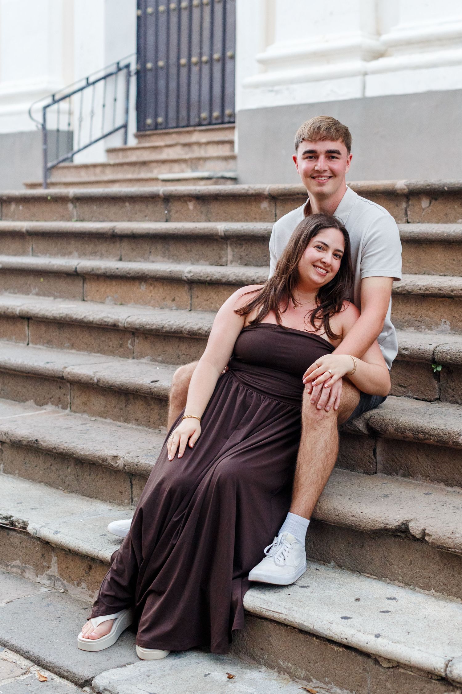 Couples portrait on the steps of the Catedral Basilica Menor de San Juan Bautista in Old San Juan, Puerto Rico.