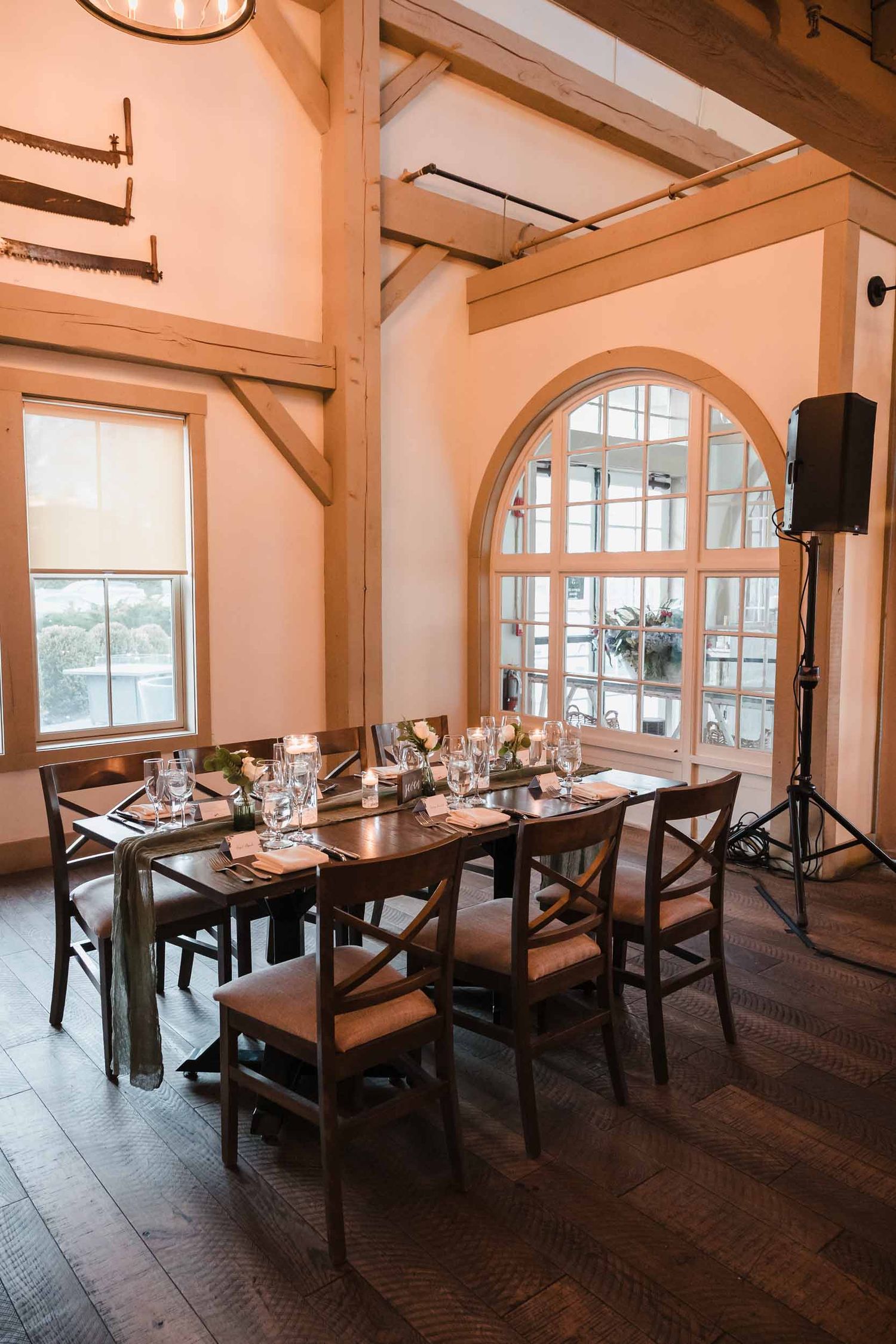 Rustic wedding table setting with greenery runner, candles, and glassware at Briar Barn Inn reception