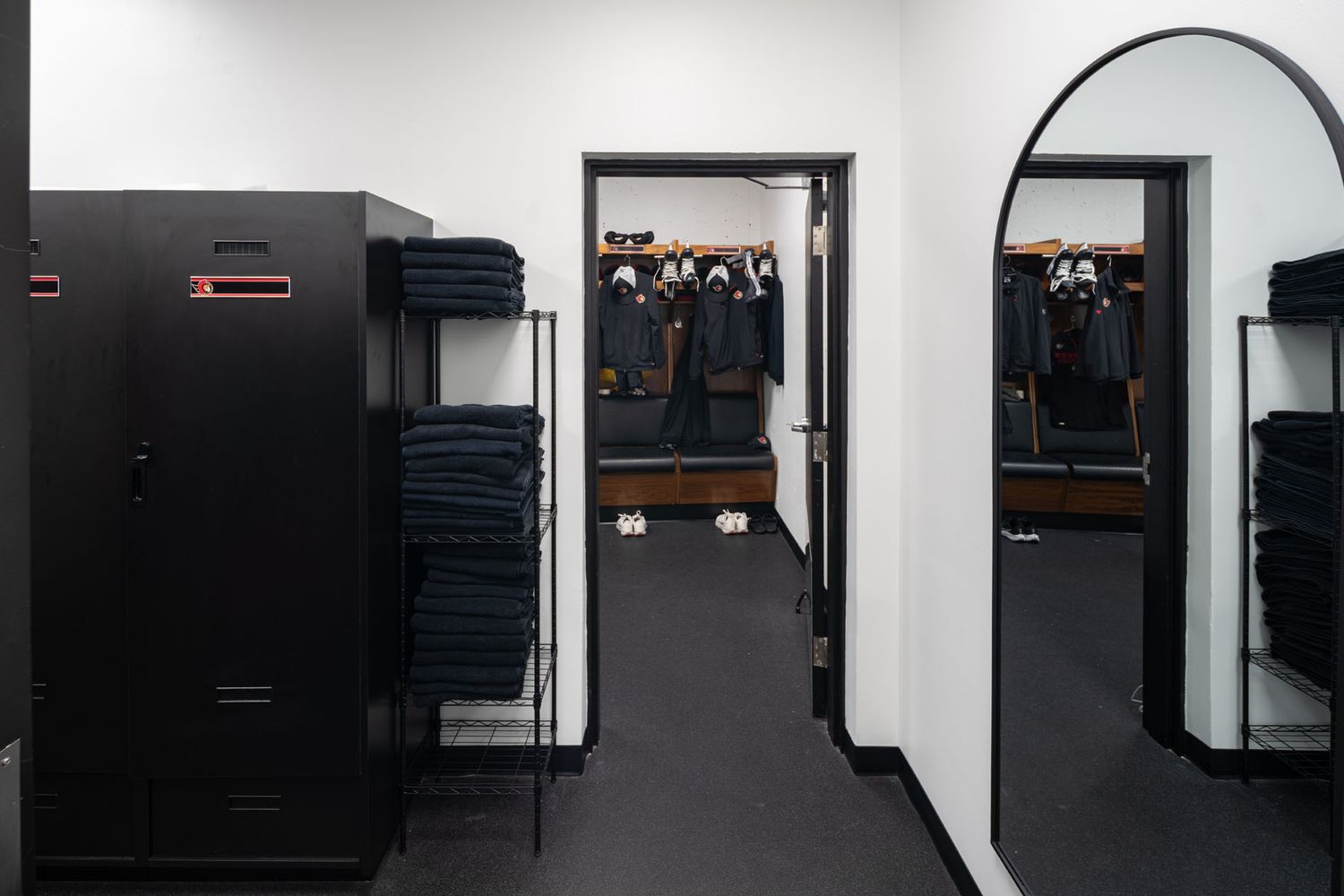 Clean architectural photography of the Ottawa Senators locker room entrance, emphasizing minimalist interior design and spatial flow
