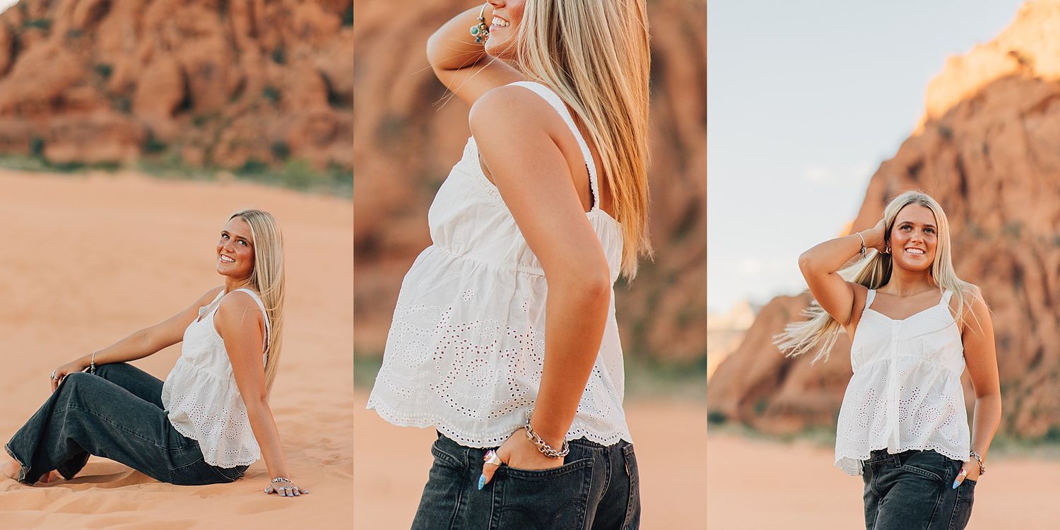 Pregnant woman in white top and dark jeans posing in desert landscape with red rock formations at golden hour.