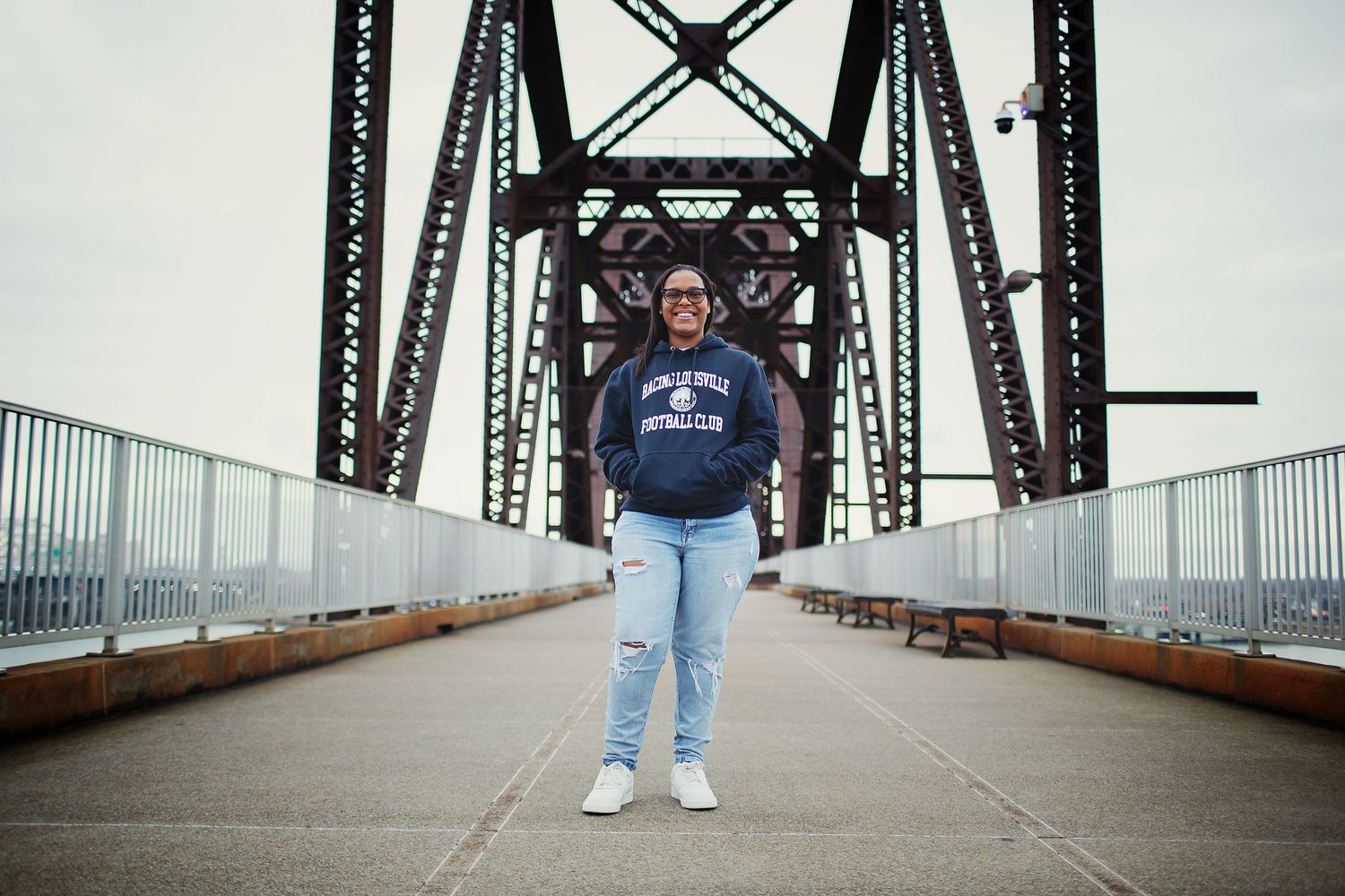 picture of a girl standing on big four bridge senior portraits louisville ky
