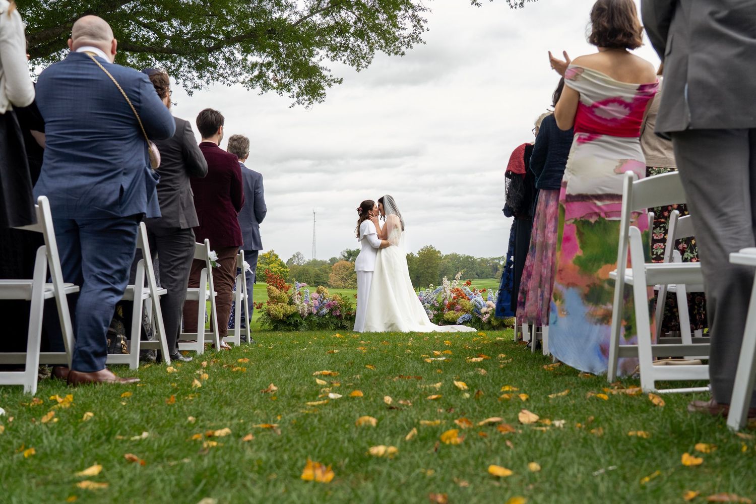 low angle shot of Lesbian wedding couple after the first kiss.