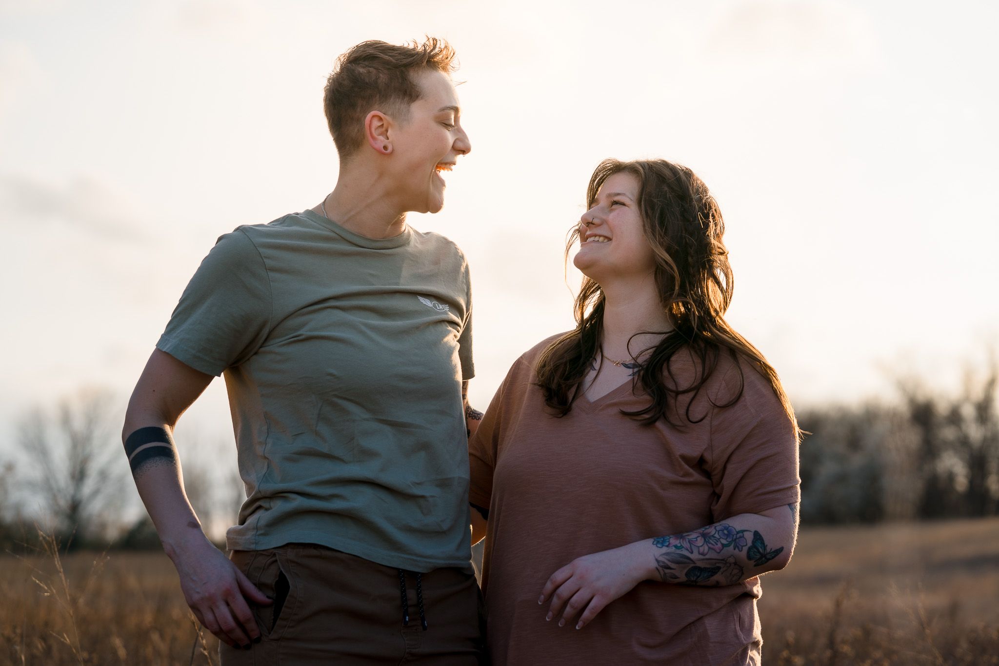 A couple shares tender moments in a golden field during sunset, captured in a series of romantic poses.