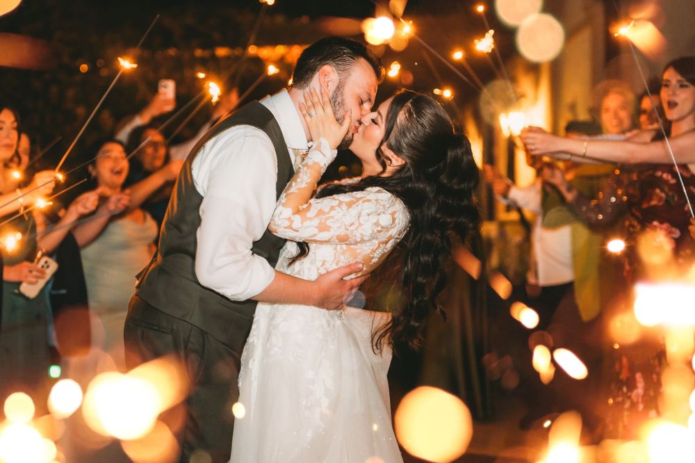 Bride and groom kissing during a sparkler send-off at Potomac Point Winery & Vineyard wedding reception
