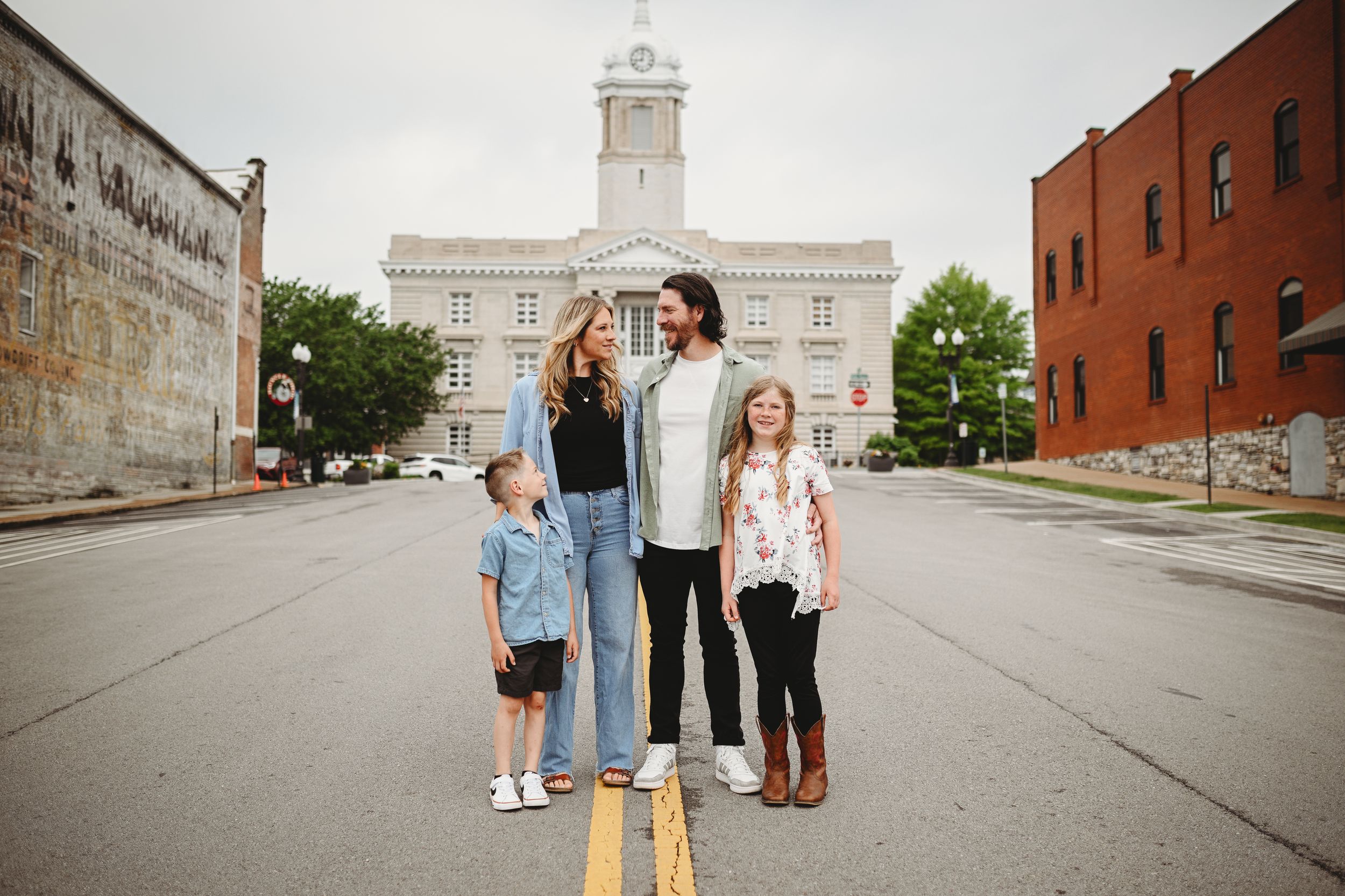 A series of outdoor photos showing people standing against a brick wall and historic building backdrop.
