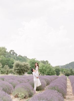 Couple posing romantically in a blooming purple lavender field in the countryside.
