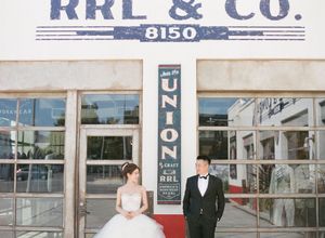 Bride and groom pose in wedding attire in front of vintage RRL and Co. storefront with Union signage.