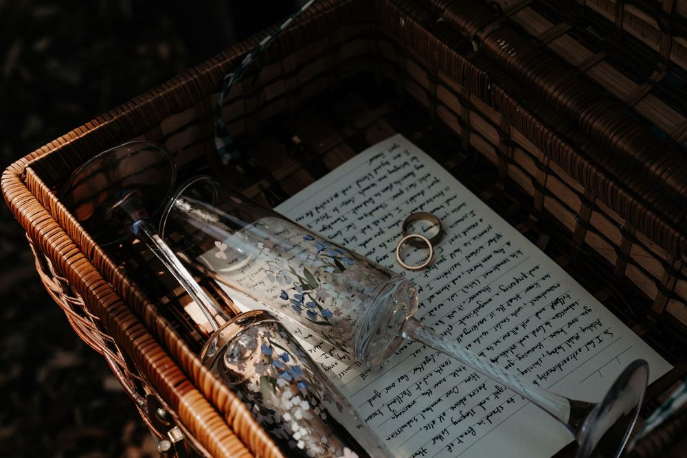Handwritten pages from an old journal or diary illuminated by warm lighting on a dark wooden surface.