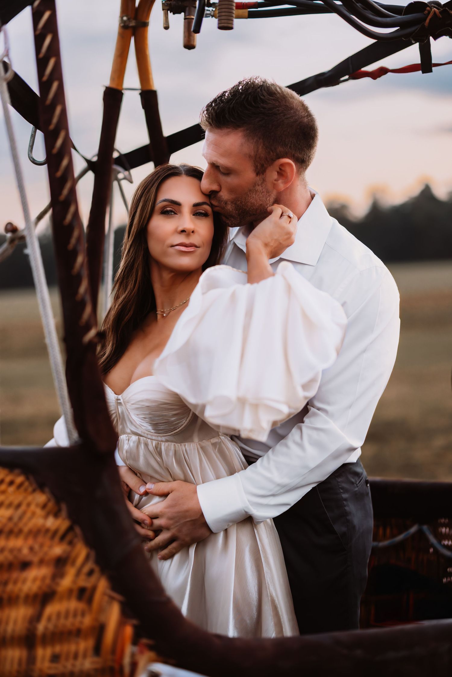 Fall Family Photo Session at Manassas Battlefield. Child blows dandelion seeds at sunset in a dreamy outdoor scene.