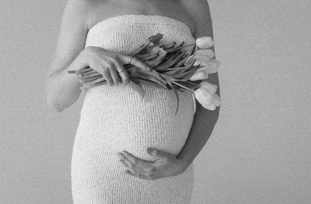 Artistic black and white close-up shots of a pregnant woman's belly.