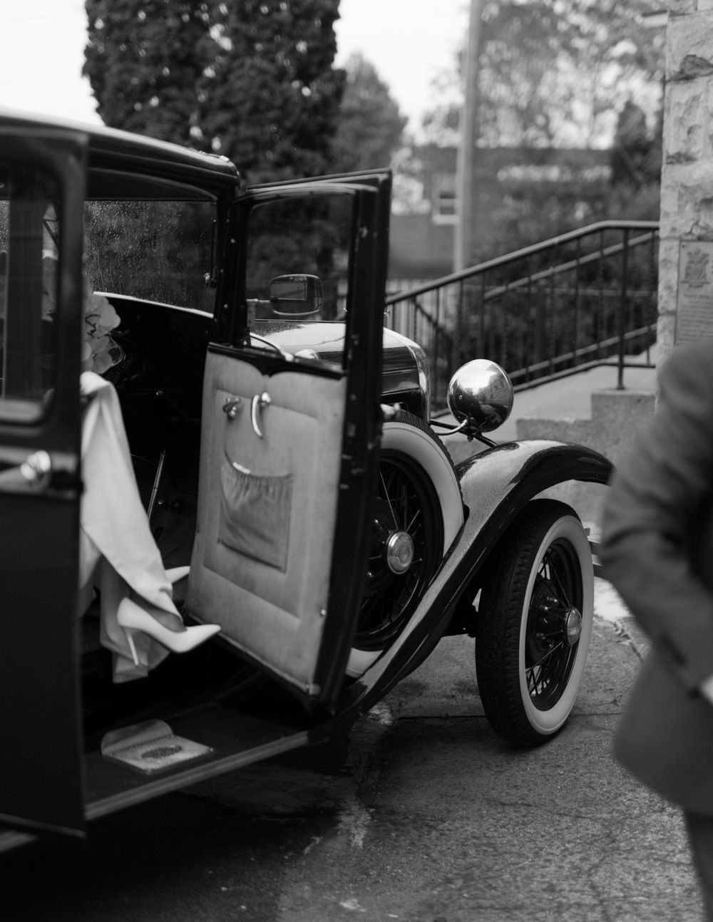 Vintage black and white car photographed at a wedding venue.