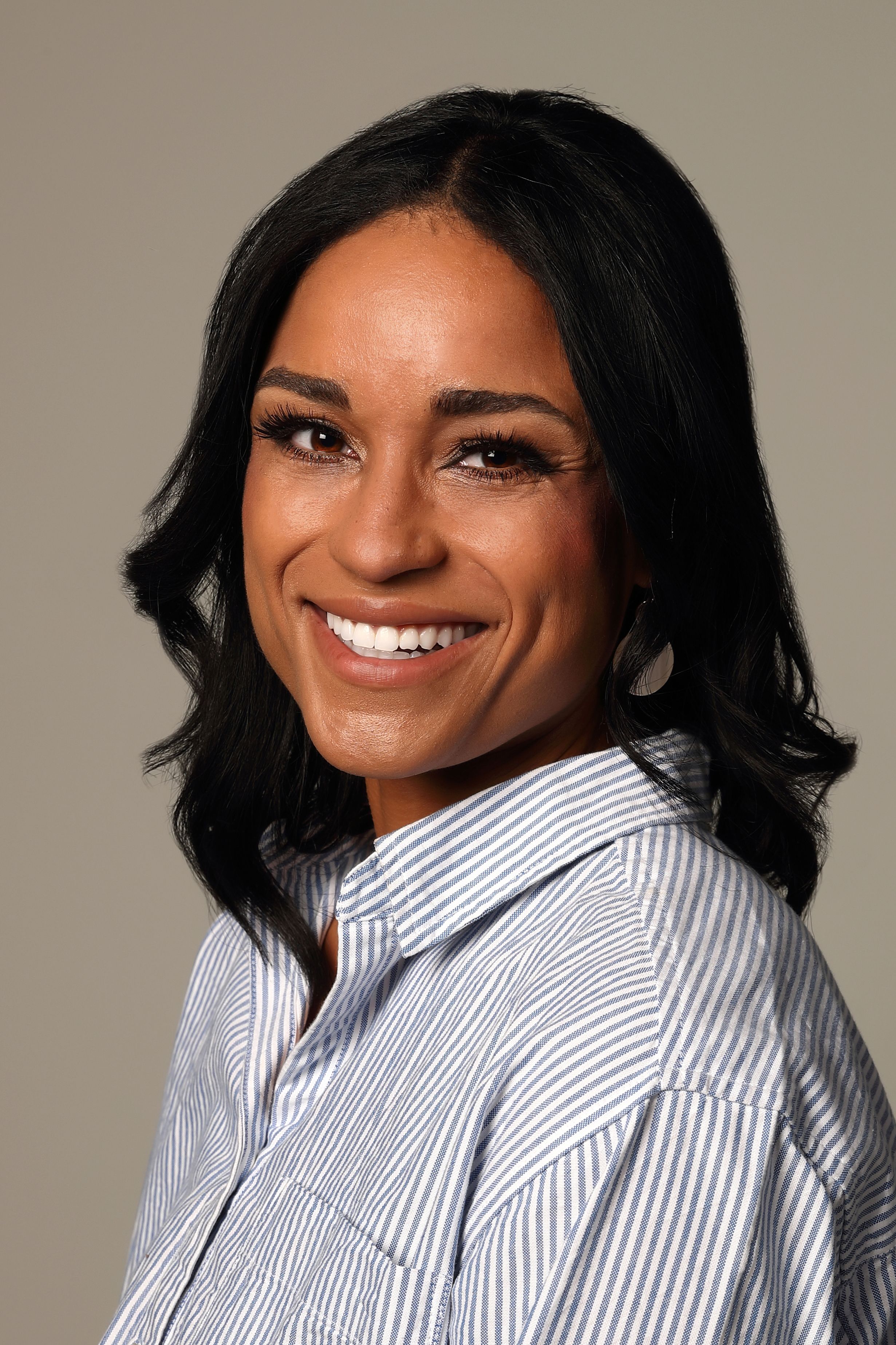 A series of professional headshots showing someone in a striped button-down shirt against a neutral background.