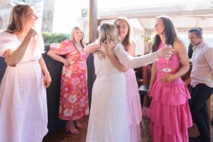 Bride being greeted by friends.L