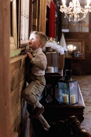Young boy looking over window ledgeL