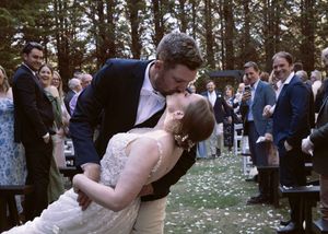 After being married moments before, couple does a surprise dip on their way down the aisle