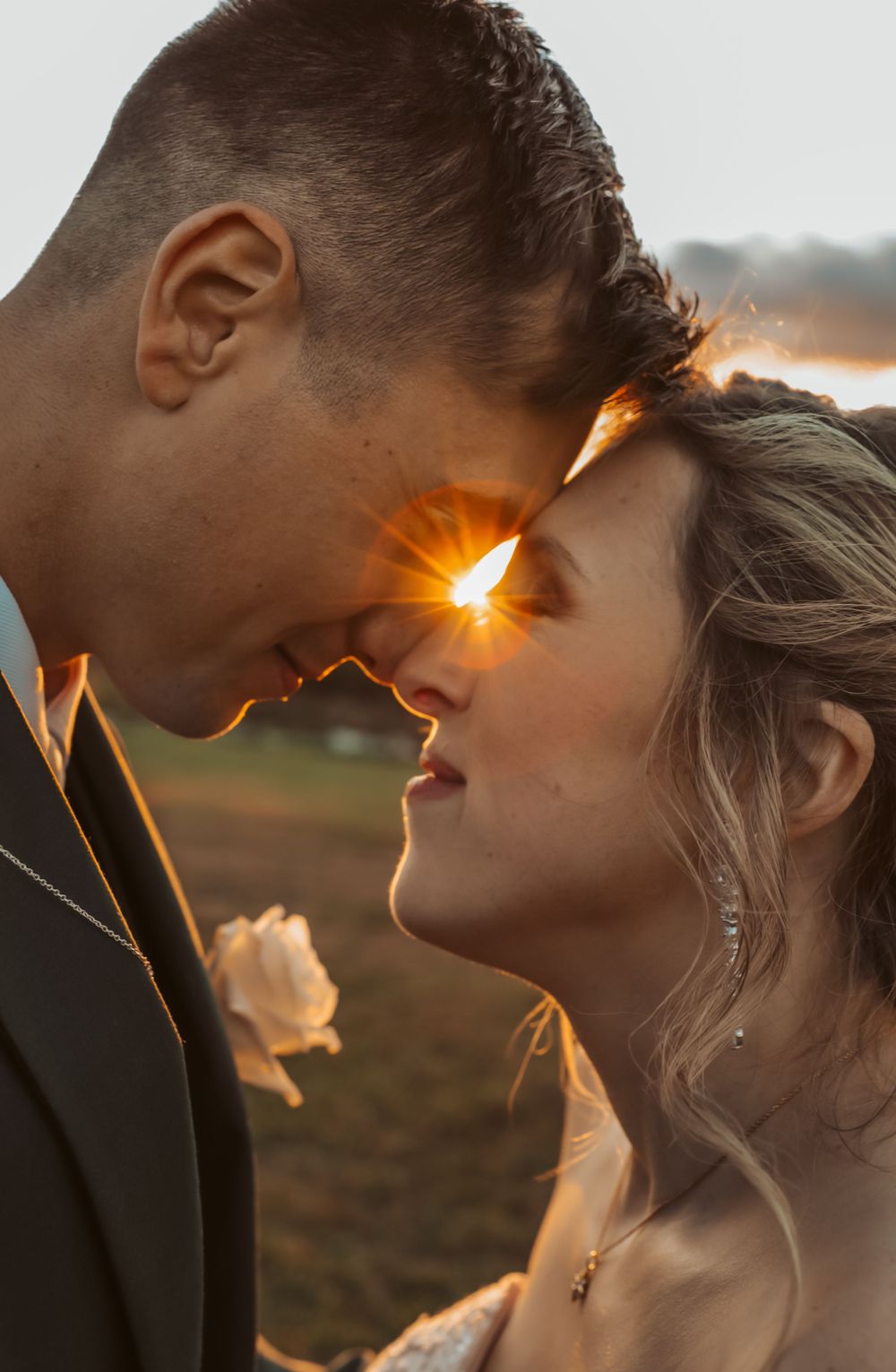 Bride and groom nose to nose Maine wedding sunset