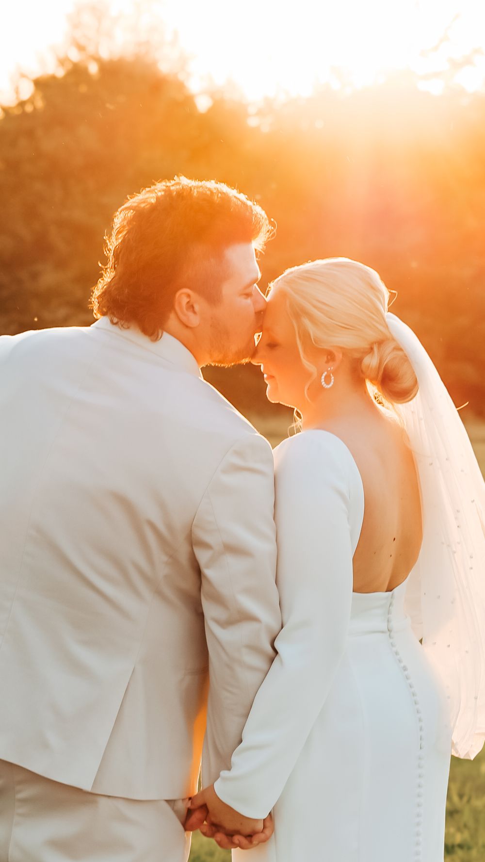 Bride and groom forehead kiss Maine wedding sunset