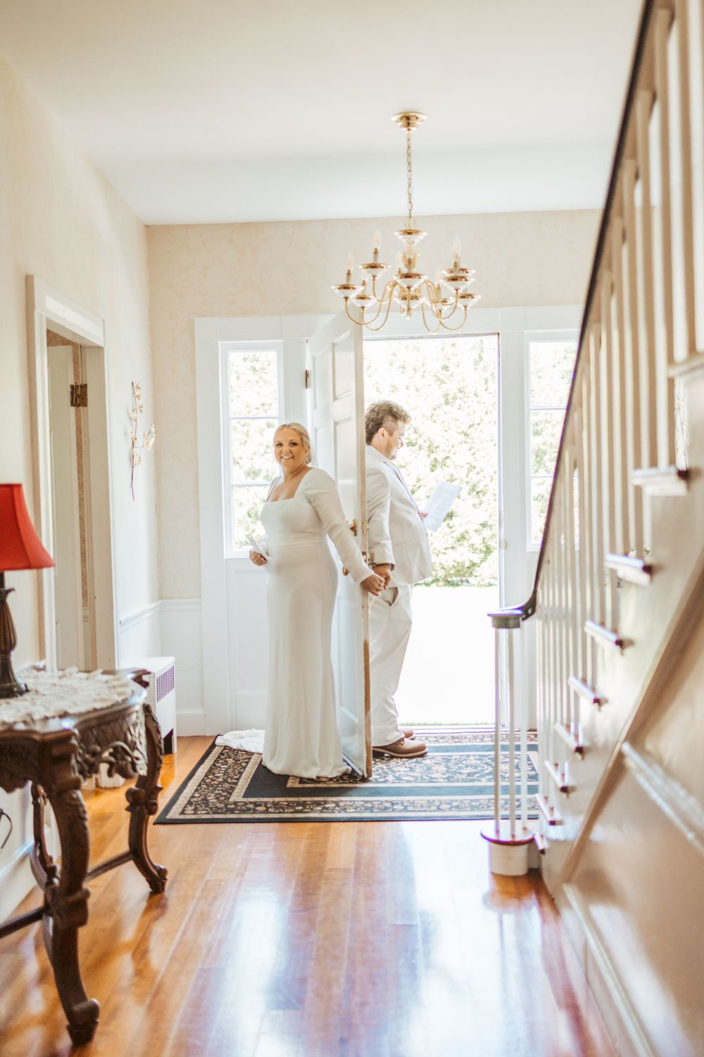bride and groom exchanging vows behind door in Maine