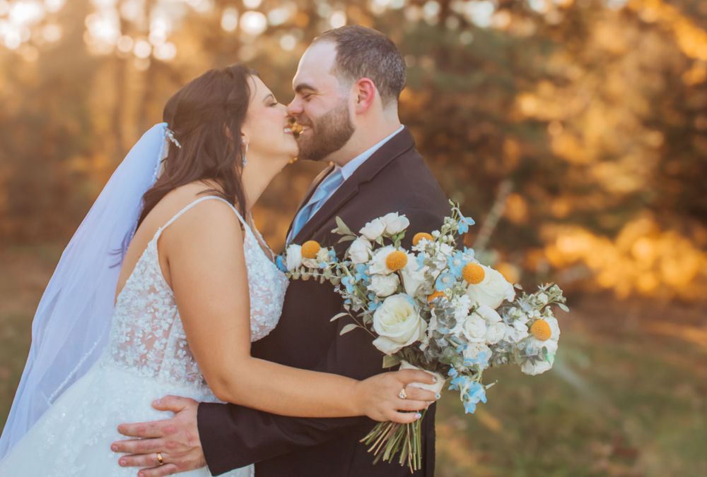 Husband and Wife sharing a kiss under the sun in Maine