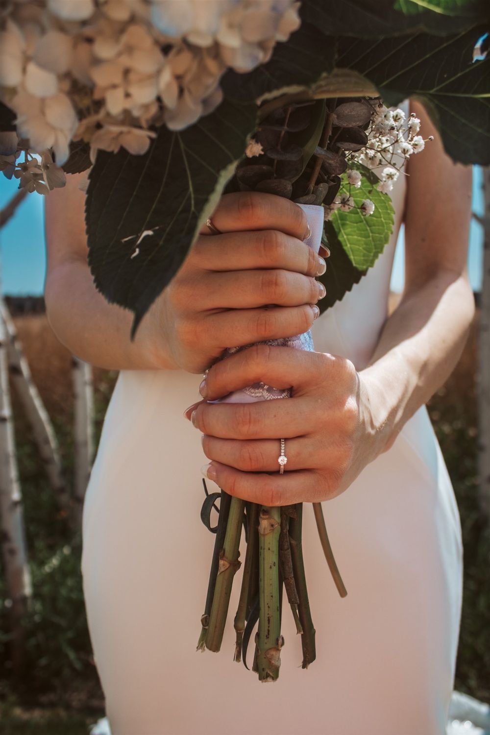 Close-up of bride’s ring and bouquet Maine wedding