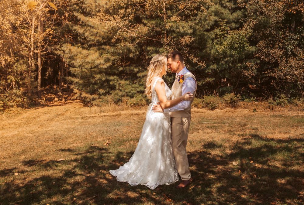 Bride and Groom nestled with tree shade in maine