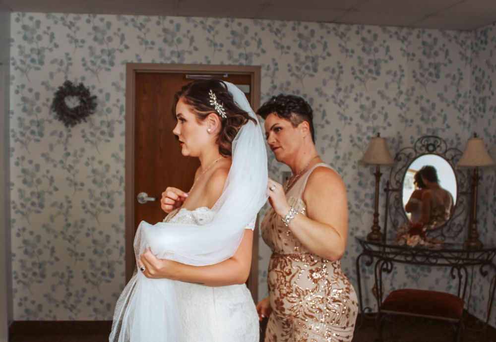 Mother helps with dress in Michigan