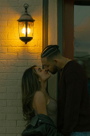 Close-up of a couple about to kiss, captured in downtown Littleton during their engagement session, filled with love and anticipation.
