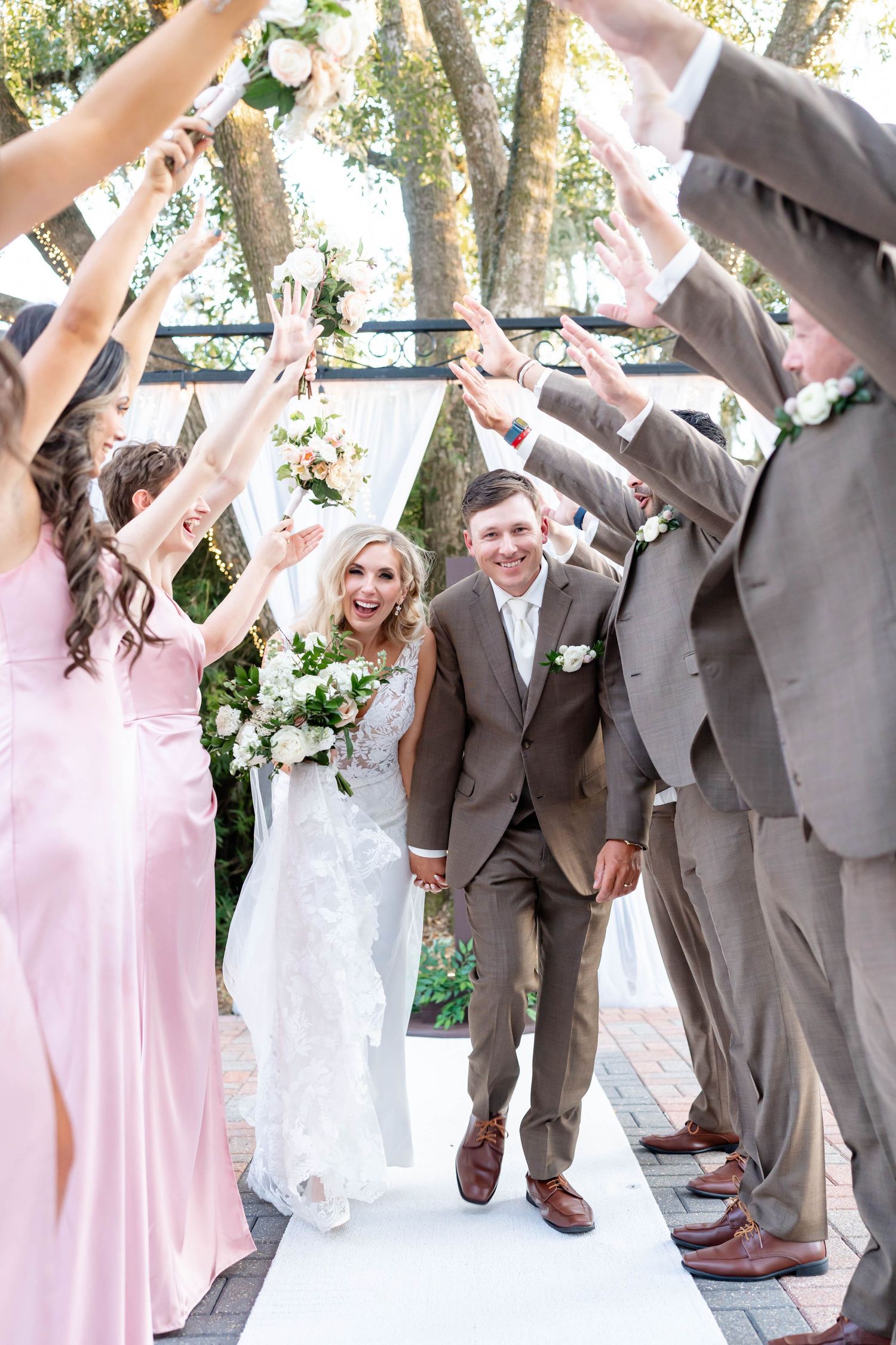 bride and groom kiss in front of bridal party