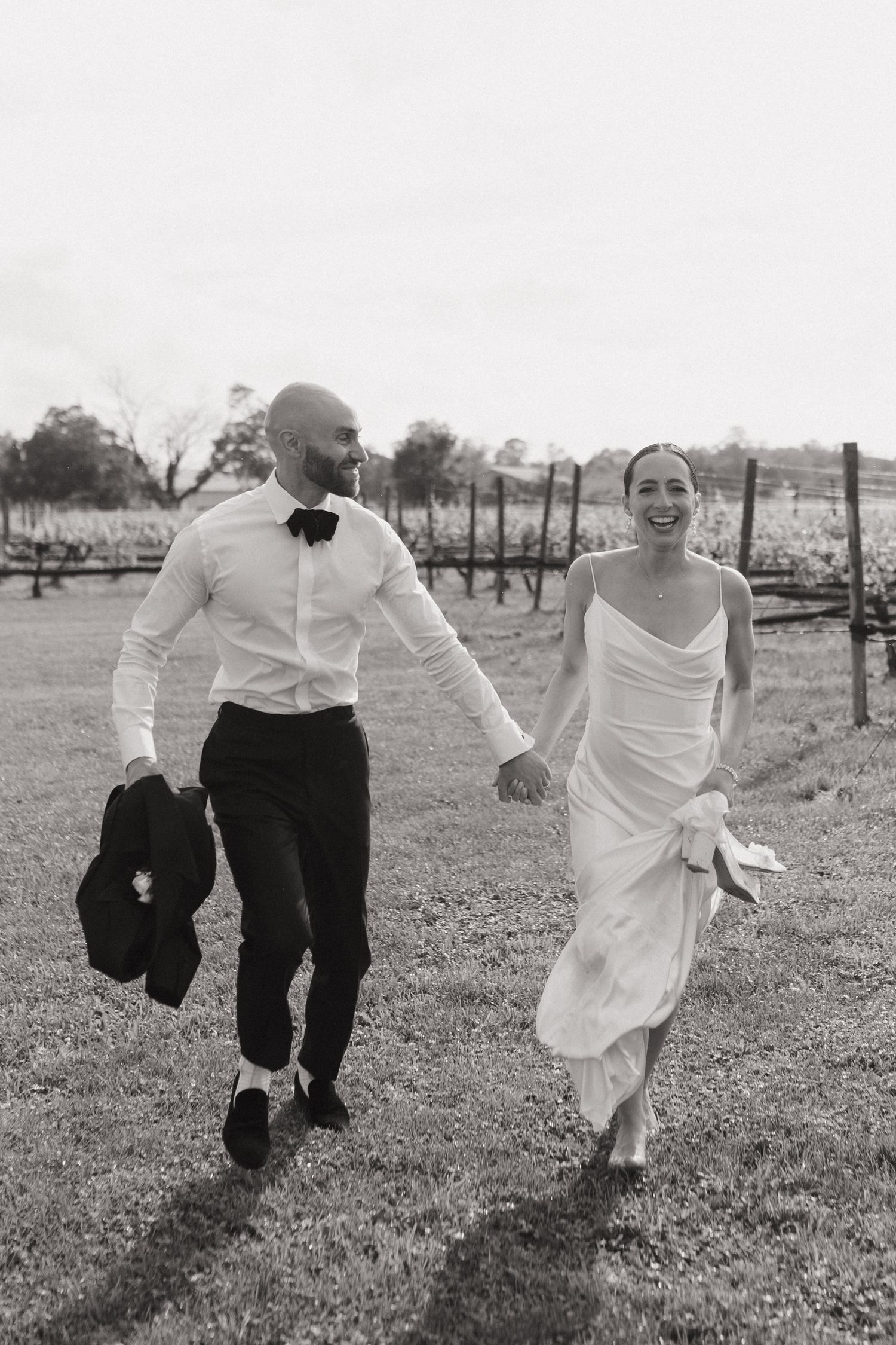 Bride and Groom running through vineyards at Long Island Wedding venue