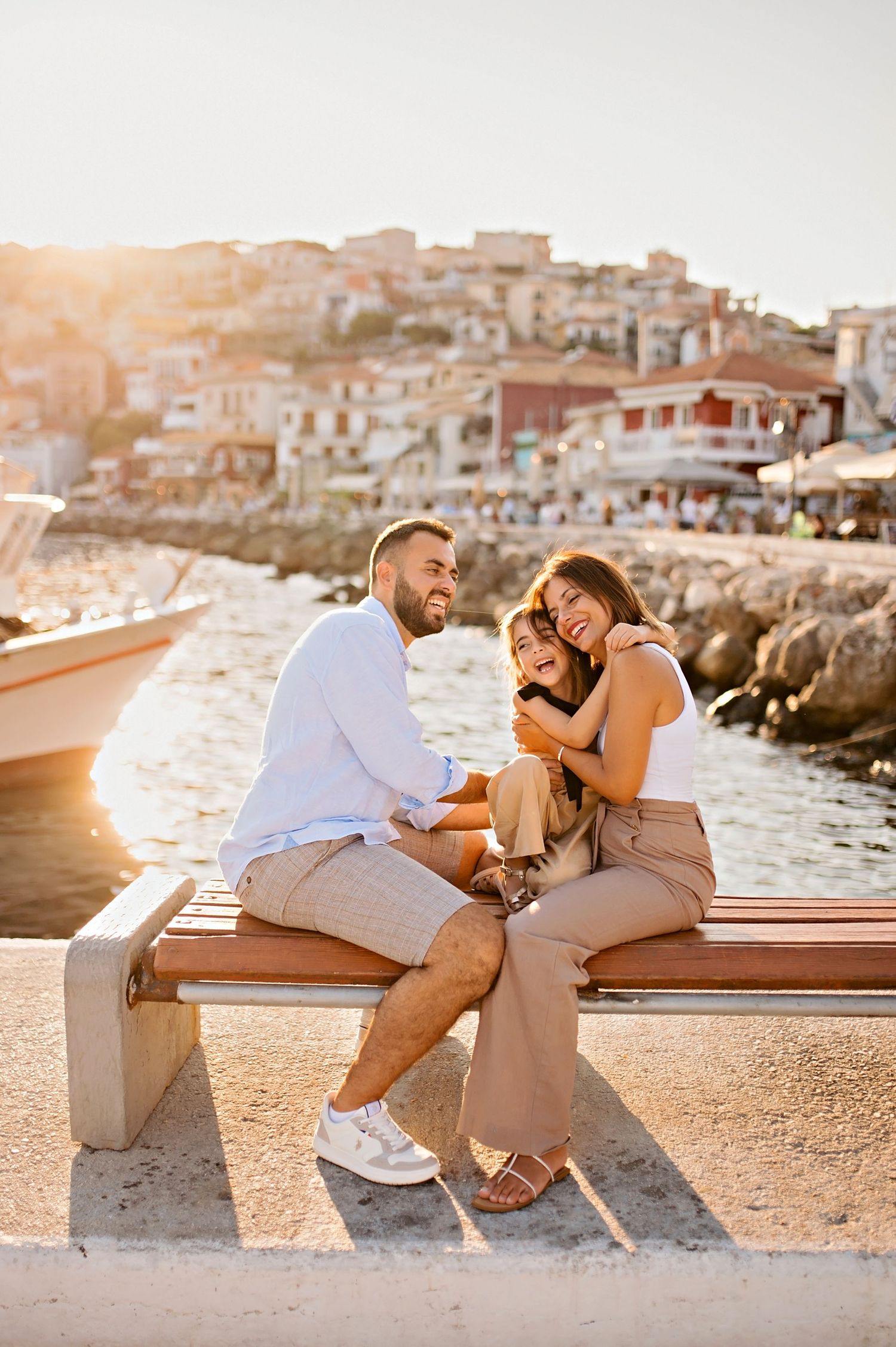 Sunset seaside portrait with Mediterranean coastal town backdrop.