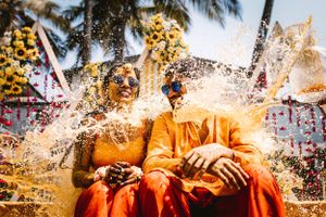 Vibrant orange and gold colors with confetti during a celebratory moment at an outdoor event.