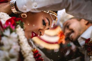 Close-up artistic shot of traditional Indian wedding jewelry and decorative elements.