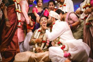Joyful celebration with pink and maroon colors at a traditional Indian wedding ceremony.