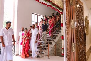 Traditional Indian wedding ceremony setup with ornate decor and red floral arrangements.