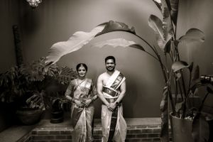Black and white artistic wedding photography with tropical plants and architectural elements.