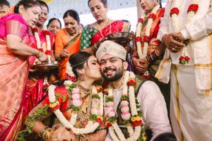 Festive wedding celebration with guests participating in traditional Indian ceremonies.