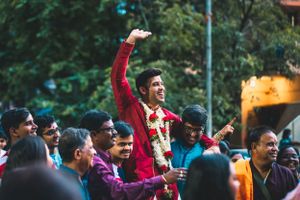 Outdoor celebration with guests dancing and enjoying festivities in natural setting.