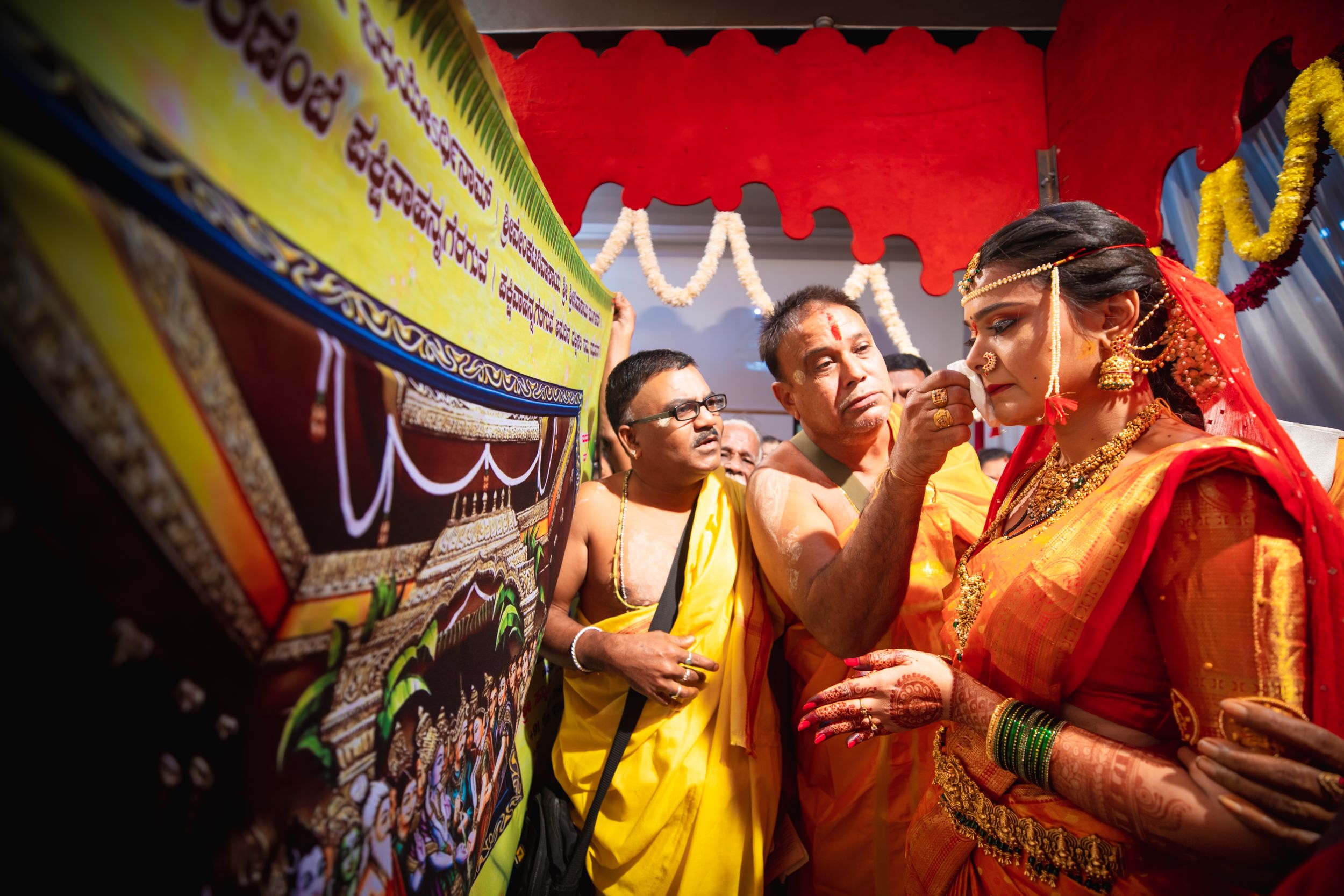 Vibrant marigold garlands and decorative elements at a traditional Indian wedding ceremony.