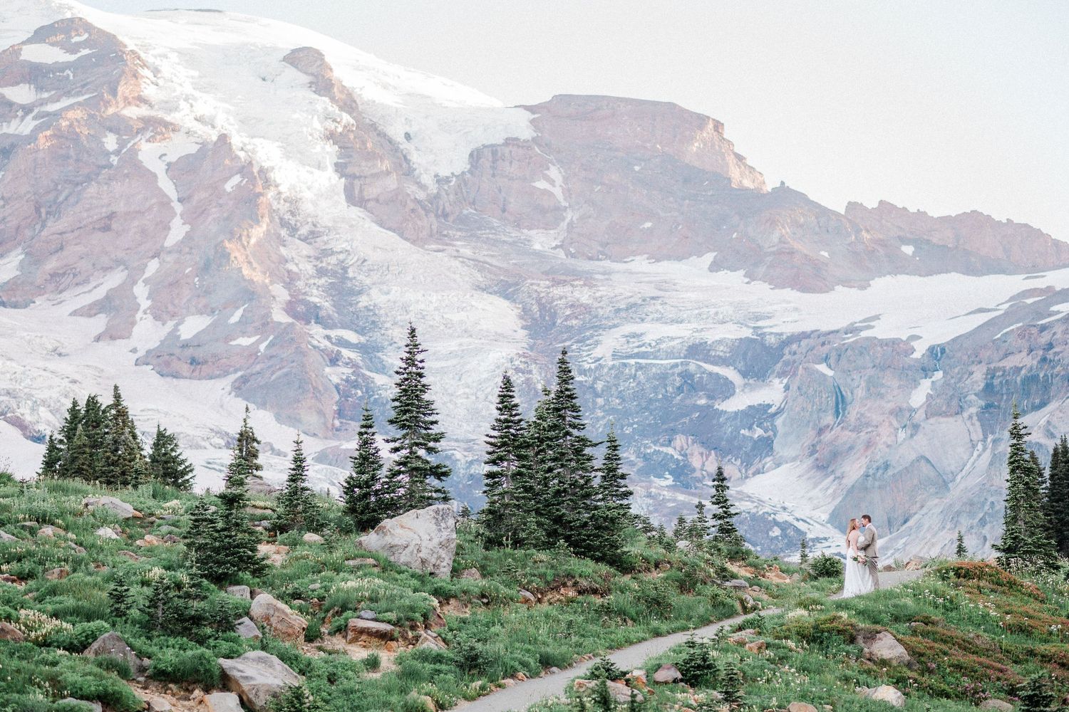 Mt. Rainier elopement at sunrise surrounded by wildflowers. Photo by Washington Elopement Photographer, Pine + Vow.