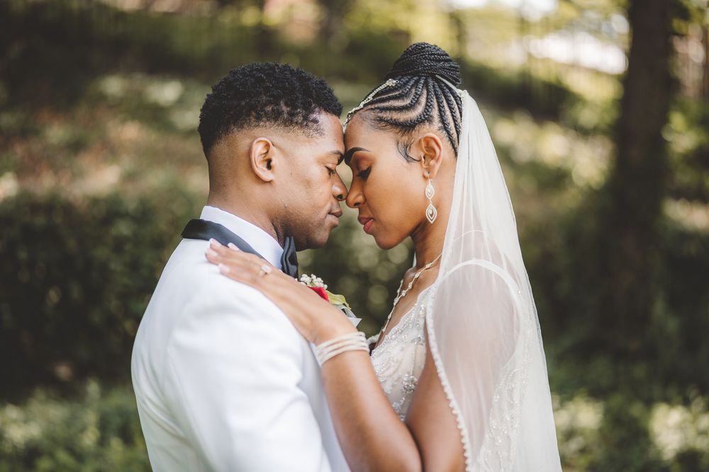 Romantic outdoor wedding portraits captured in a garden with natural lighting.
