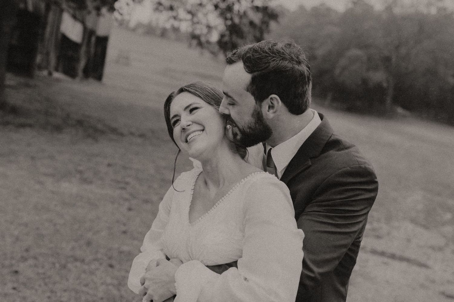 Black and white portrait captures tender romantic moment between newlyweds.