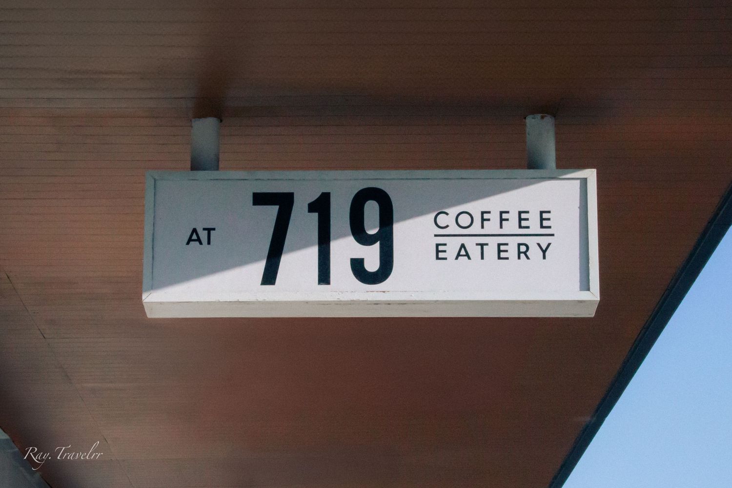 Sign showing '719 Coffee Eatery' mounted on a wall.