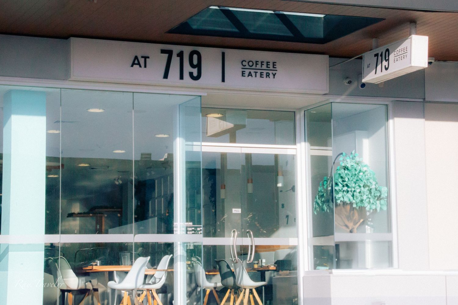 Exterior storefront of 719 Coffee Eatery with glass windows and modern signage.