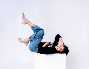 Fun studio portrait of a child captured mid-laughter on a white backdrop. In Belleville Ontario