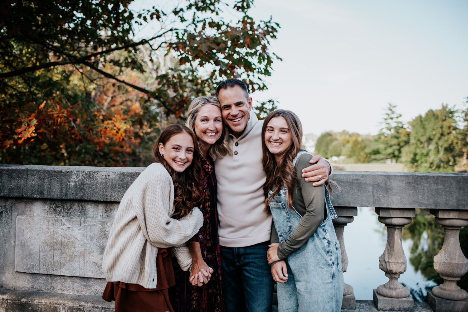 A collection of outdoor family portraits in autumn settings with fall foliage and natural backdrops.