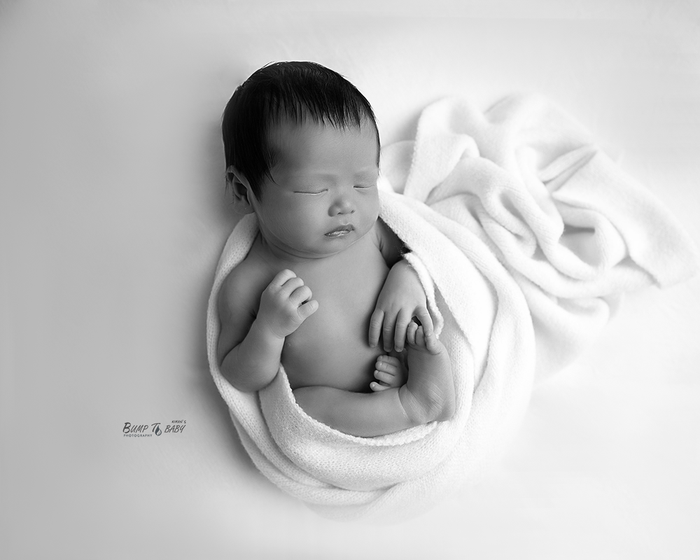Newborn baby wrapped in soft cashmere at a newborn photography studio in Croydon, Melbourne East.